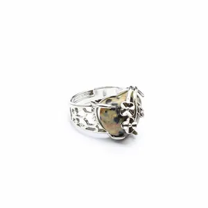 Detailed view of adjustable heart-shaped stone ring with intricate silver flower motifs