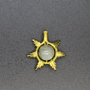 Detailed macro view of handmade wire-wrapped sun pendant with a natural stone centerpiece.