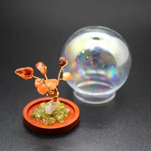 Detail of a natural stone tree of life micro-landscape with an iridescent glass dome