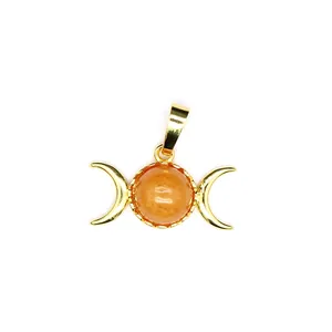 Detailed macro shot of 24K gold-plated triple moon pendant with round orange gemstone