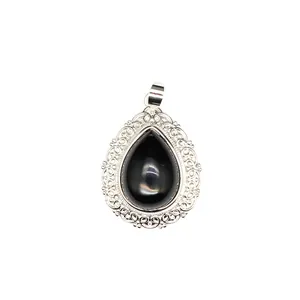 Detailed close-up of a teardrop gemstone pendant with an ornate silver lace frame