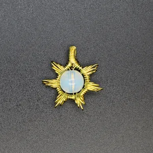 Close-up of handmade gold wire-wrapped sun pendant with opalite stone center