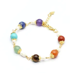 Detailed view of handmade 7 chakra natural stone bracelet with pearls and 14K gold