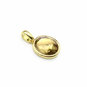 Detailed macro view of an elegant gold oval faceted brown natural stone jewelry pendant