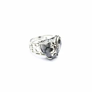 Close-up of heart-shaped natural stone ring with delicate rose flower metal overlay