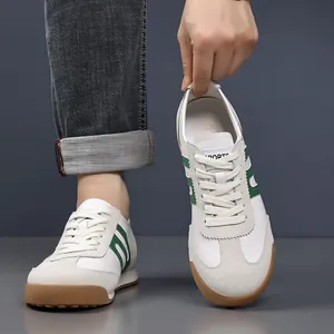 Detailed view of white and green men's sneakers with classic gum sole