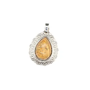 Detailed close-up of a vintage teardrop natural stone pendant with silver filigree edges.