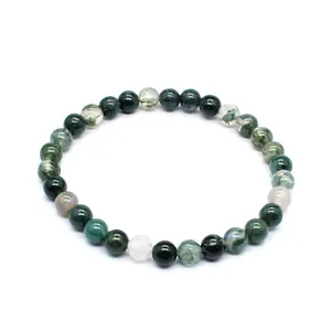 Close-up of 6mm natural stone round bead bracelet with green and white mineral patterns.