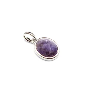 Detailed macro view of faceted oval purple natural stone pendant set in silver metal bail