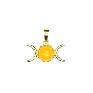 Macro detail of triple moon goddess pendant with honey yellow cabochon stone in gold