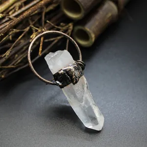 Close-up of a natural raw quartz crystal pendant with rustic metal wrap