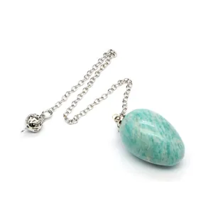 Close-up of natural amazonite egg crystal pendulum and silver decorative chain detail