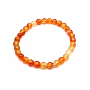 Macro detail view of 6mm translucent orange carnelian natural stone beads in a round bracelet