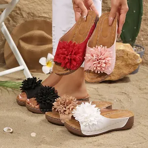 Detailed view of women's wedge sandals with large flower embellishments in various colors