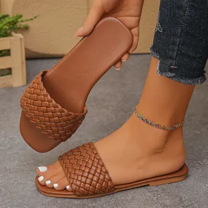 Brown woven flat slides for women showing handmade texture and stylish beach footwear