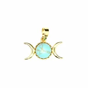 Detail view of a gold-plated triple moon goddess pendant with a turquoise stone inlay.
