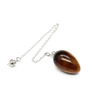 Detail of a natural tiger's eye stone egg pendulum with a silver link chain.