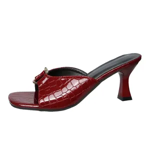 Side view of dark red crocodile embossed square toe high heel sandal with metal buckle