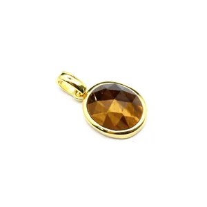 Detailed view of an oval faceted tiger eye stone pendant in a gold setting