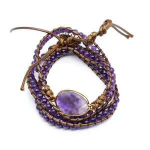 Macro view of handmade multi-wrap bracelet with natural amethyst beads and stone.