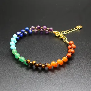 Close-up view of a handmade 7 chakra natural stone bead bracelet with gold wire
