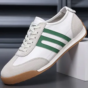 Classic white and green GAT-style sneakers with durable gum sole detail