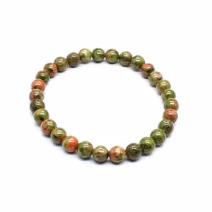 Detailed view of natural dragon blood stone beads on a minimalist 6mm stretch bracelet