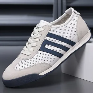 Close-up of men's casual GAT sneakers featuring perforated leather and grey suede textures