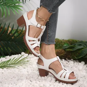 Close-up detail of white chunky heel sandals with elegant fish mouth and strap design