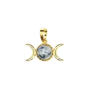 Detail of a 24K gold plated triple moon pendant with a marbled blue stone centerpiece