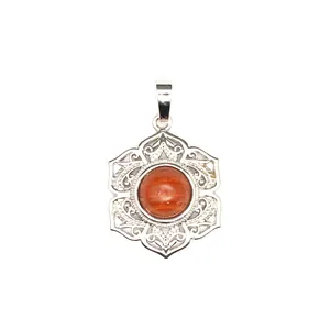 Vue rapprochée d'un pendentif filigrané en argent orné d'un cristal rond de couleur orange.