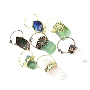Handmade raw crystal stone pendants with labradorite and sunflower charms on white