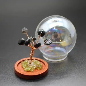 Close-up of mini natural stone life tree ornament with glass dome for home decor.