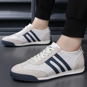 Detailed side view of breathable men's German training sneakers in white and navy