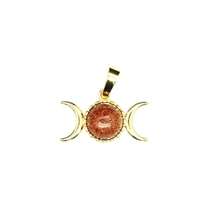 Detailed macro view of 24K gold plated triple moon goddess pendant with goldstone
