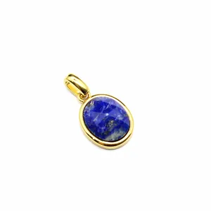 Close-up detail of a faceted oval lapis lazuli gemstone pendant with a gold-plated frame