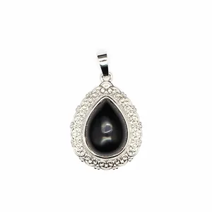 Close-up of teardrop-shaped stone pendant with intricate silver lace border detail.