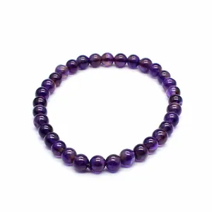 Close-up detail of a 6mm natural purple amethyst stone beaded stretch bracelet for women