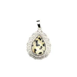 Detailed shot of a teardrop natural stone pendant with silver filigree decoration