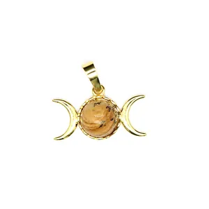 Macro view of a 24K gold plated triple moon goddess pendant with natural stone