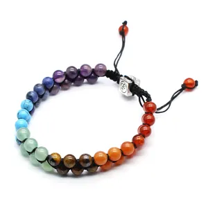 Detail view of 7 chakra stone bracelet with adjustable black cord and silver Om bead.