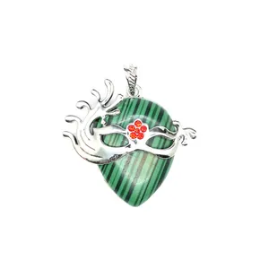 Close-up of teardrop malachite pendant with silver masquerade mask and red rhinestones