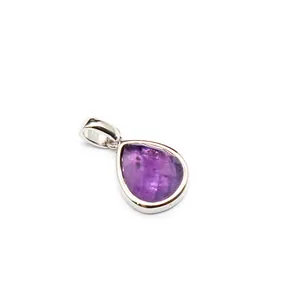 Detailed close-up of a faceted purple gemstone teardrop pendant in silver bezel setting