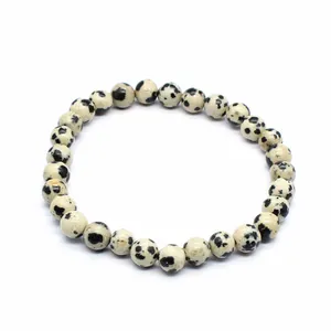 Close-up of minimalist 6mm natural stone round bead bracelet on white background