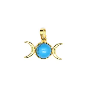 Detail view of gold-plated crescent moon pendant with central blue round stone.