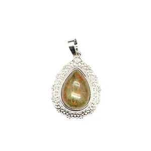 Macro detail of water drop amethyst pendant with ornate silver-tone floral lace border