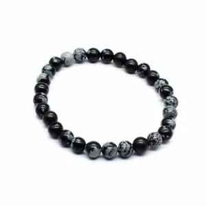 Detailed macro view of a minimalist 6mm snowflake obsidian round beaded bracelet for women.