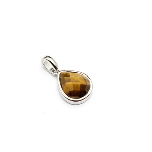 Detailed close-up of a faceted teardrop tiger's eye pendant with polished silver metal setting