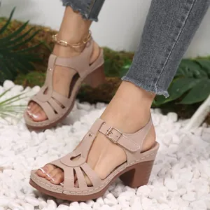 Elegant beige peep-toe chunky heel sandals featuring intricate cutout detail and adjustable ankle strap