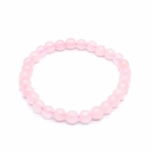 Close-up view of a 6mm pink natural stone bead bracelet featuring smooth round beads